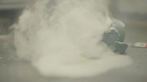 Smoke grenade is thrown over a really dirty blue carpet. Stock Footage 182037627