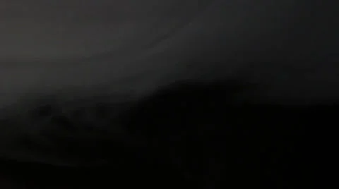 Smoke hovers at ceiling on black background Видео 34124093