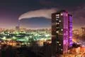 The smoke from the industrial pipe in the city at night Photo