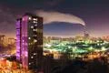 The smoke from the industrial pipe in the city at night Photo
