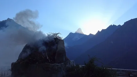 Smoke of juniper incense burning on stone altar in the Himalayas Stock Footage 78524261