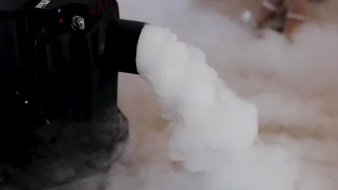 The smoke machine releases a large cloud of smoke onto the stage on dance floor Stock Footage 235470687