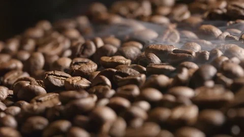 Smoke over a roasted coffee beans on the oven Video stock 72405861