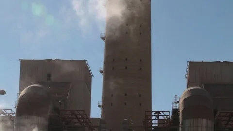 Smoke passing in front of a chimney of a coal mine power plant Stock Footage 121338006