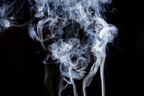 Smoke pattern on black background. Smoke wisps create ghostly texture. Rising Stock Photos