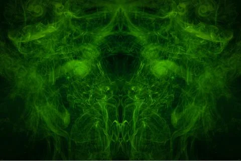 Smoke of pattern green  in the form of horror monster on a dark isolated back Stock Photos