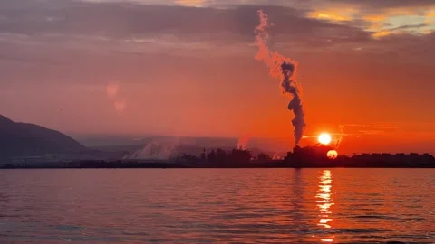 Smoke Pollution at sunset by the sea, Harmful fumes coming from factory chimney Stock Footage 284035813