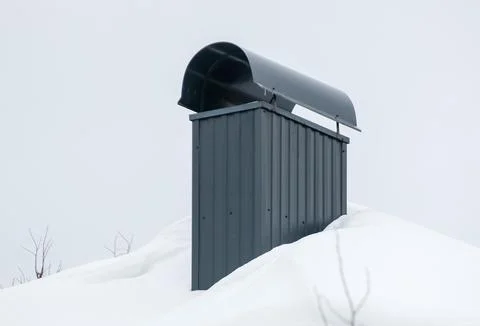 Smoke, rectangular, black exhaust pipe on the roof of a modern house. Stock Photos