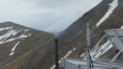 Smoke rises from chimney at mountain station Stock Footage 345388468