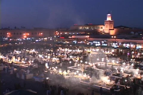 Smoke rises from food stalls at a night-time market in Marrakesh Morocco. Stock Footage