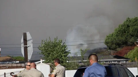 Smoke rises from house in the background Stock Footage 114413166