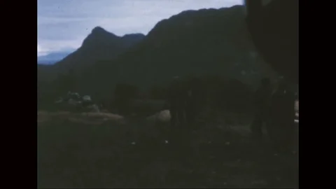 Smoke rising from blast of explosive charges set on hillside - 1968 Stock Footage 98245162