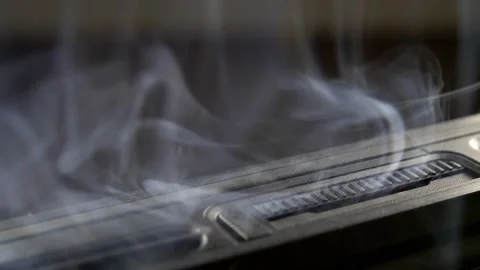 Smoke Rising from Burnt Electronic Computer Device due to Short Circuit Stock Footage 134594967