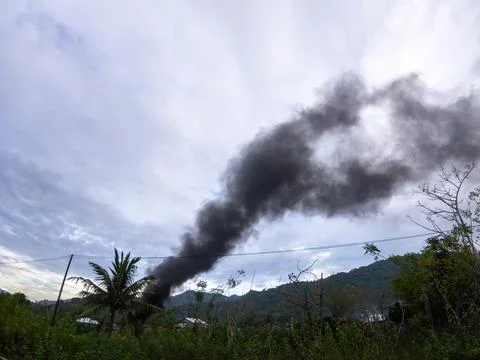 Smoke Rising from Distant Landscape 写真素材