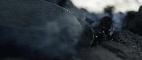 Smoke rising from extinguished campfire Stock Footage 69199653