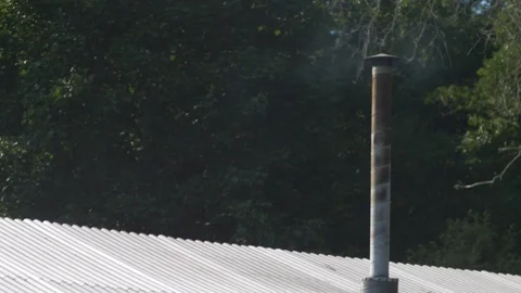 Smoke rising from tall chimney on plate roof Stock Footage 108564394