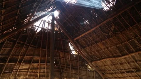 Smoke rising through gaps in grass roof 動画素材 42150846