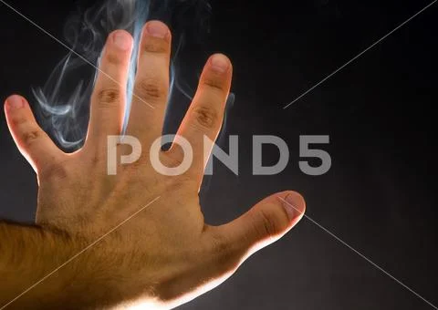 Smoke rising up through human hand. Spirits, spiritual background Stock Photos