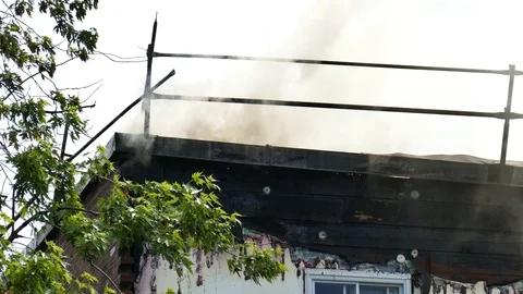 Smoke on the roof a structure Stock Footage 114800042