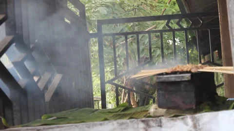 Smoke from satay being grilled using charcoal Stock Footage 281178512