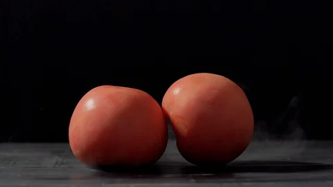Smoke in slow motion on black background and tomatoes Stock Footage 112430316