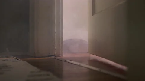 Smoke slowly flows through a crack in the door of a bedroom 스톡 동영상 134299865