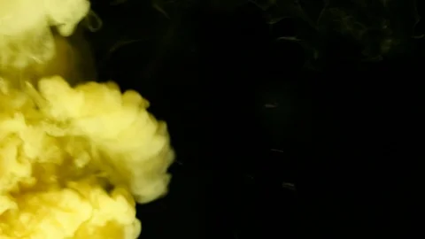 Smoke sprayed yellow motion in the black  Stock Footage 96359630