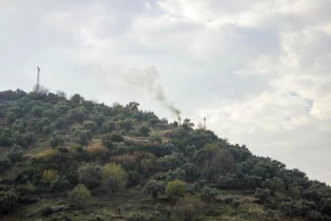 Smoke spread up on top of the mountain Stock Photos