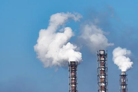 Smoke stack of coal power plant on blue sky background. 写真素材
