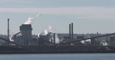 Smoke stack factories with lake in Stock Footage 125959039