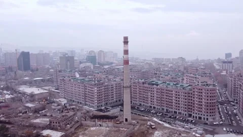 Smoke stack from an industrial zone redeveloped into a residential space Stock Footage 325036273