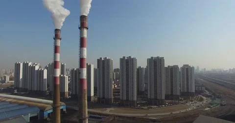 SMOKE STACK POLLUTION AT FACTORY NEAR APARTMENTS IN CHINA Stock Footage 62691509
