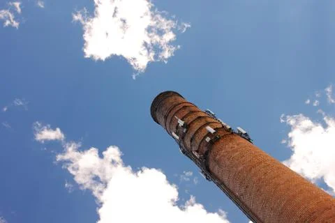 Smoke Stack Rises into Blue Sky Stock Photos