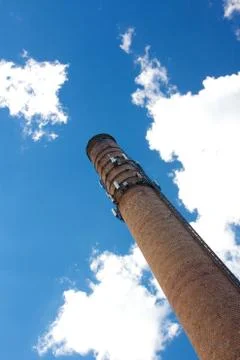 Smoke Stack Rises into Blue Sky Stock Photos