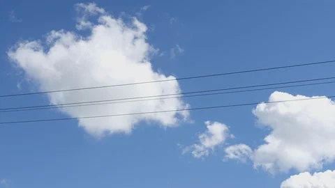 Smoke stacks, clouds with power lines in the foreground. 스톡 동영상 116809933