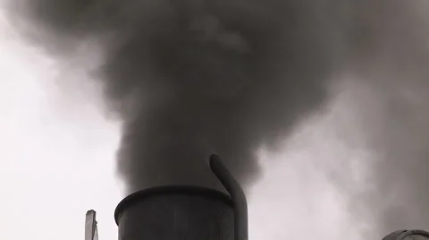 Smoke stacks from industry belching carbon and gases into the environment Stock Footage