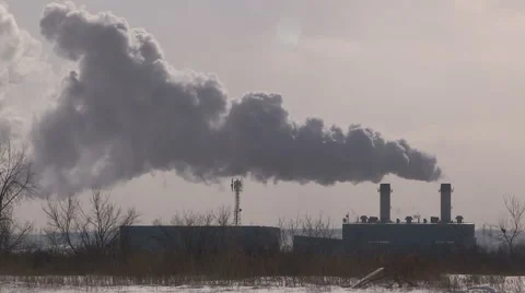 Smoke stacks from industry belching carbon and gases into the environment Stock Footage