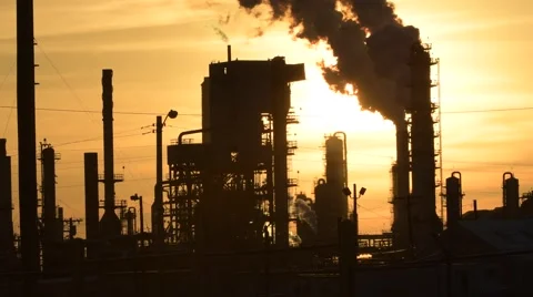 Smoke stacks from our refinery at sunset Stock Footage 64952188
