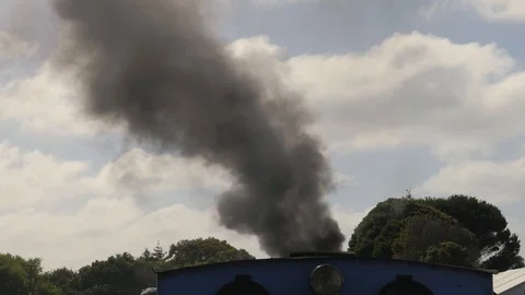 Smoke from steam engine train funnel against blue sky Stock Footage 102334273