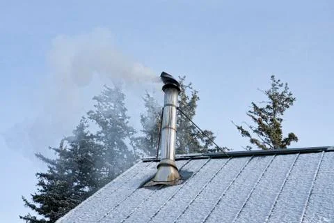 Smoke from stove pipe in winter Stock Photos