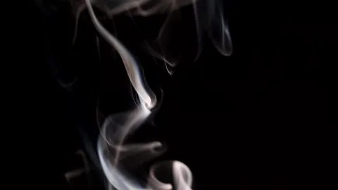 Smoke streaming in the dark from a burning incense stick. Stock Footage 147040113