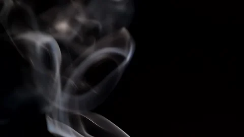 Smoke streaming in the dark from a burning incense stick. Stock Footage 147040128