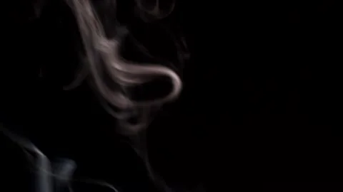 Smoke streaming in the dark from a burning incense stick. Stock Footage 147040160