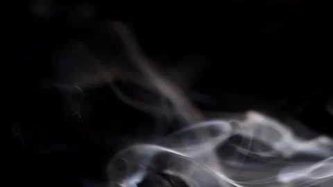 Smoke streaming in the dark from a burning incense stick. Stock Footage 147040189