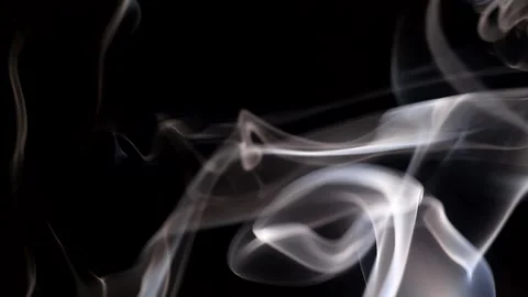 Smoke streaming in the dark from a burning incense stick. Stock Footage 147040199