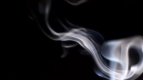 Smoke streaming in the dark from a burning incense stick. Stock Footage 147040221