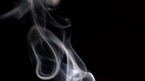 Smoke streaming in the dark from a burning incense stick. Stock Footage 147040235
