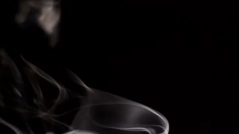 Smoke streaming in the dark from a burning incense stick. Stock Footage 147040249