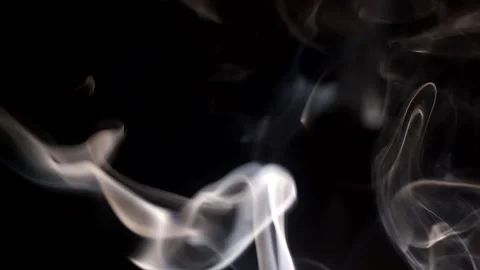Smoke streaming in the dark from a burning incense stick. Stock Footage 147040256