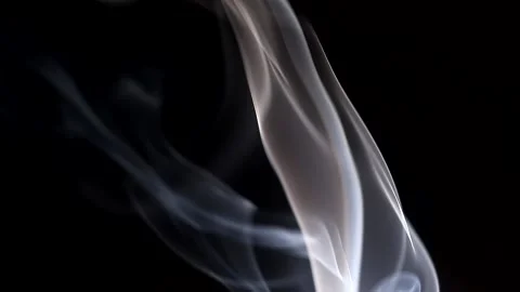 Smoke streaming in the dark from a burning incense stick. Stock Footage 147040293